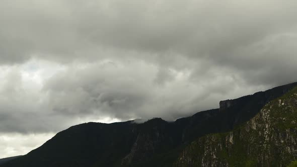 Time lapse shot of low clouds moving over mountains