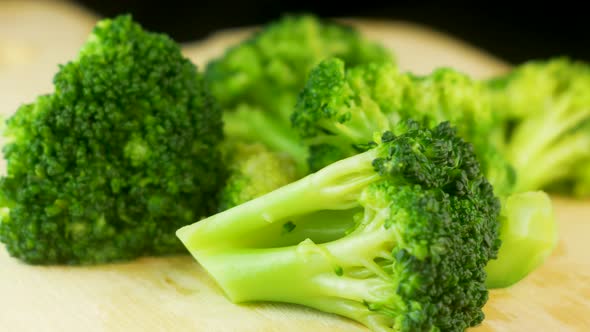 Close-up of fresh raw broccoli rotate on a kitchen board