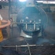 Young man pouring coffee roasted from the oven in his own factory, smoke is rising due - VideoHive Item for Sale