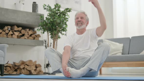 Old Man Doing Stretches on Yoga Mat at Home