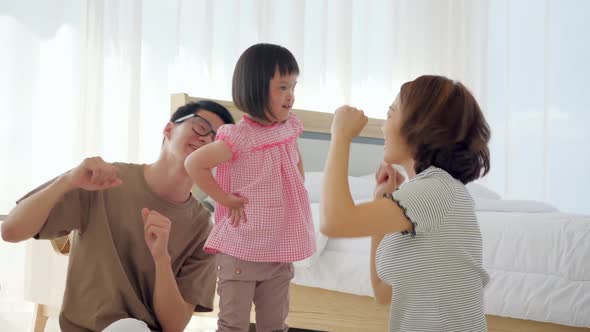 Happy family with mother, father and disabled daughter spending time together at home.