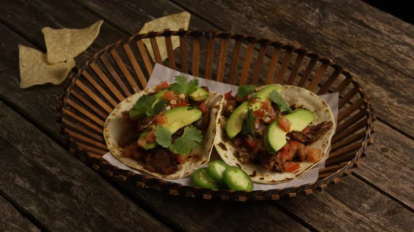 Rotating shot of delicious tacos on a wooden surface - BBQ 135