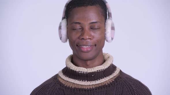 Face of Young Happy African Man Smiling Ready for Winter