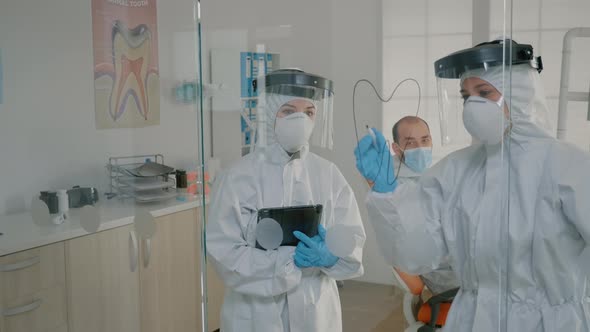 Stomatological Doctor Drawing Tooth on Glass with Marker