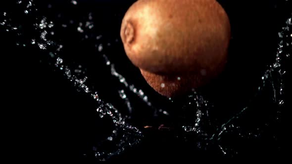 Super Slow Motion Ripe Kiwi Fall on the Water with Splashes