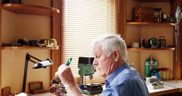 Horologist repairing a watch