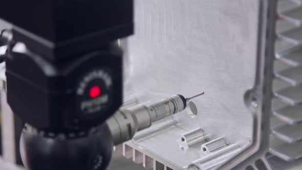 Macro footage of a coordinate measuring machine CMM measuring metal part