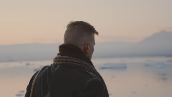 Travelling Man Walking In Icelandic Landscape At Sunset