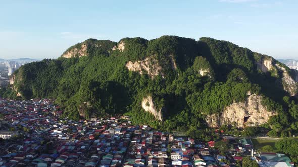 Fly toward Batu Caves near the suburban