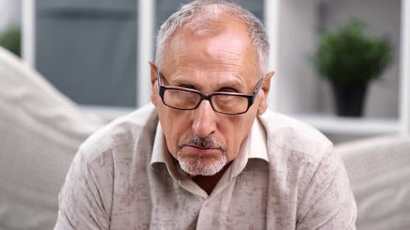 Portrait of Depressed Mature Man in Glasses with Sad Face Expression