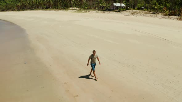 Man Walks on a Wide Beach