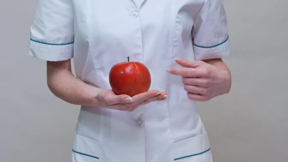 Nutritionist Doctor Healthy Lifestyle Concept - Holding Organic Red Apple