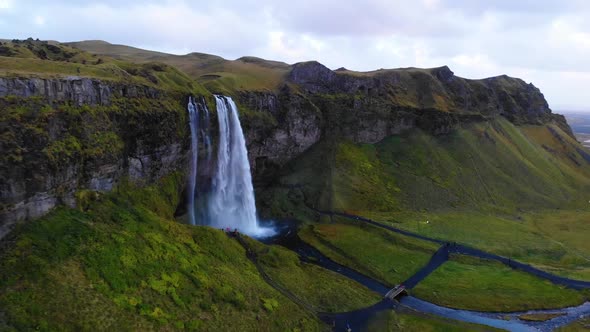 Waterfalls in green mountainous terrain