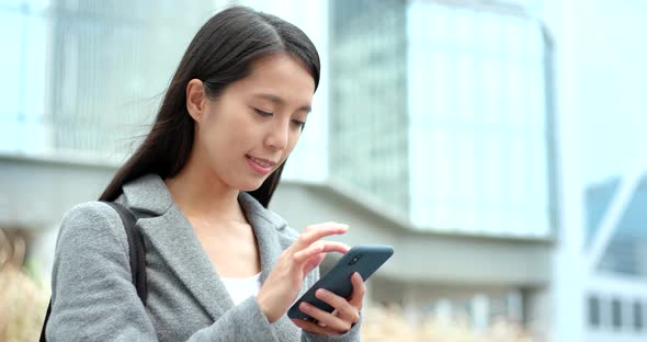 Business woman use of smart phone in city 