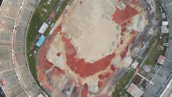 Stadium construction site. Aerial top down view. Drone descending shot