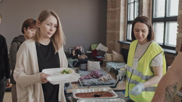 Volunteers Providing Refugees with Meal