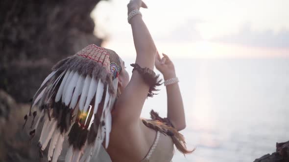 Spiritual Rituals Shaman Woman Dancing in Wild Rocky Nature Wearing Eagle Feather Culture Ornament