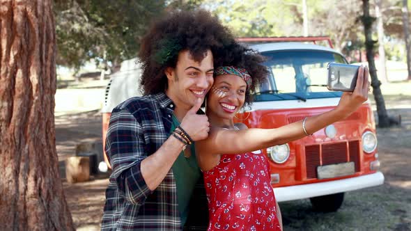 Couple taking selfie with mobile phone in park 4k