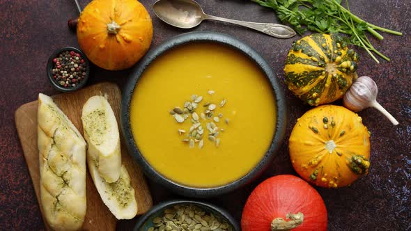 Homemade Vegetarian Pumpkin Cream Soup Served in Ceramic Bowl