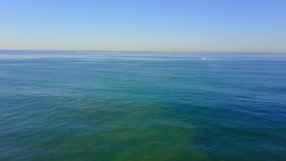 Aerial drone uav view of a motor boat and the ocean.