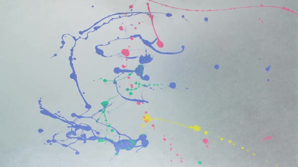 Throwing blue, green, yellow and pink paint on paper, Slow Motion