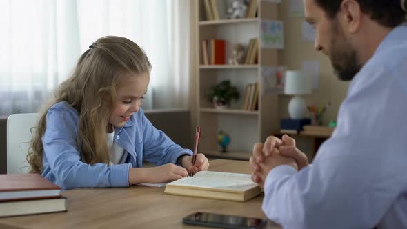 Smart Daughter Writing in Exercise Book, Caring Daddy Stroking Kids Hair