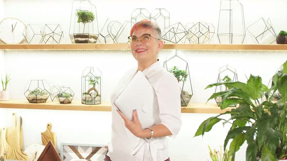 Modern Woman Florist in White Bathrobe Talking on Mobile Phone, Showing Thumb, Good News