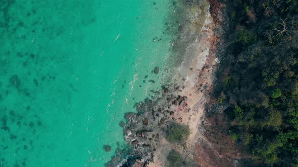 Clear Ocean Water Near Rocky Coastline Vertical Upper View