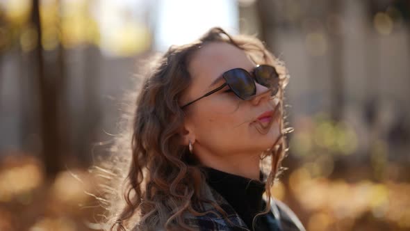 Portrait of Beautiful Woman with Dark Sunglasses in Autumn Day Closeup View