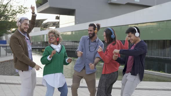 Group of Friends Having Fun Dancing to Music Together Outdoor