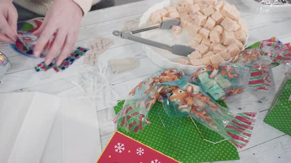 Step by step. Packaging homemade candy cane fudge into small gift bags.