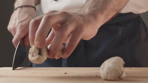 the Mushrooms Fall on a Wooden Board in the Kitchen the Cook Prepares the Food