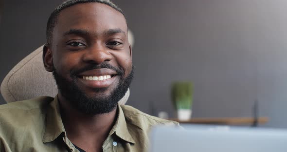 Close Up Portrait of Handsome African American Freelancer is smiling at the Camera.