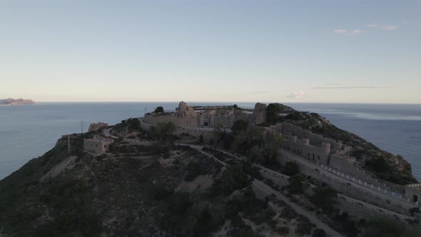 Castillitos battery and sea in background, Cartagena in Spain. Aerial circling. Sky for copy space