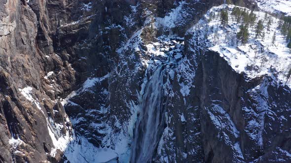 Frozen Voringsfossen and spectacular landscape with high cliffs and deep valley during wintertime wi