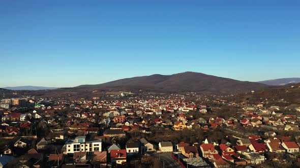 The Mukachevo City at the Evening with Beautiful Mountains Panorama Aerial View