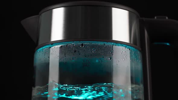 Boiling Water in a Glass Electric Kettle Rises in Bubbles in Slow Motion