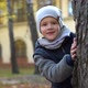 Beautiful Little Boy Hiding Behind Tree in Autumn Park - VideoHive Item for Sale
