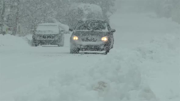 Driving in heavy snowfall on a snow covered road.