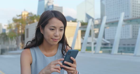 Woman look at the smart phone at outdoor