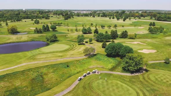 Aerial View From the Top n of the Golf Course. People and Cars on a Golf Course From a Height.