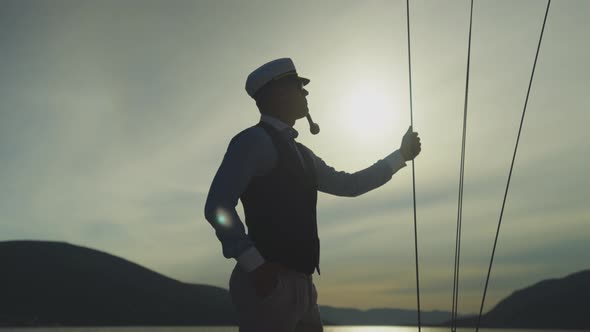 Silhouette of man standing with pipe