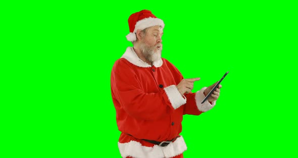 Santa claus using digital tablet 4k