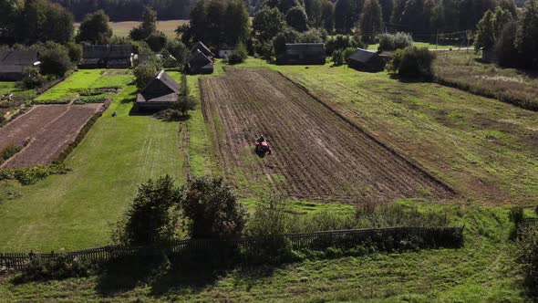 Farmer Digs Potatoes with a Small Tractor