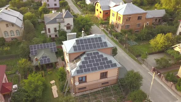 Aerial view of a private house with solar panels on roof. Photo voltaic system for renewable energy