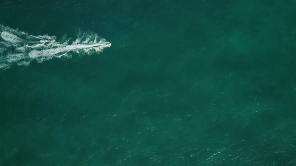 Aerial view above two jet ski sailing straight in lake in Sharjah, U.A.E.