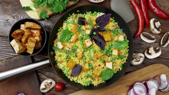 Vegetable Rice with Green Peas Carrots Tofu and Mushrooms on Wooden Background