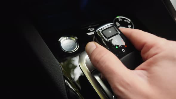 Male Hand Switches Automatic Transmission, Close-up