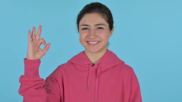 Indian Girl Showing Ok Sign with Finger Blue Background