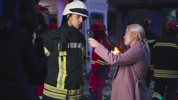Female Reporter Interviewing Rescuer in Evening